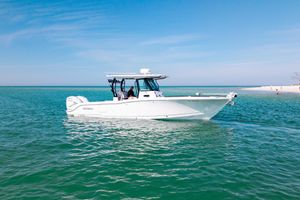 Crevalle 33 CSF 2022 Crevalle 33 CSF boat on clear turquoise water near sandy beach.