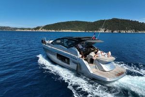 Cranchi M 44 HT 2020 Cranchi M 44 HT yacht cruising on blue ocean near scenic coastline.