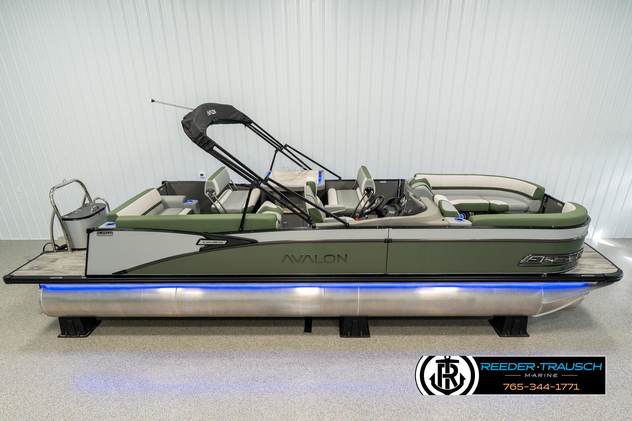 Avalon Catalina Entertainer 2025 Avalon Catalina Entertainer pontoon boat with green seating and sleek design in showroom.