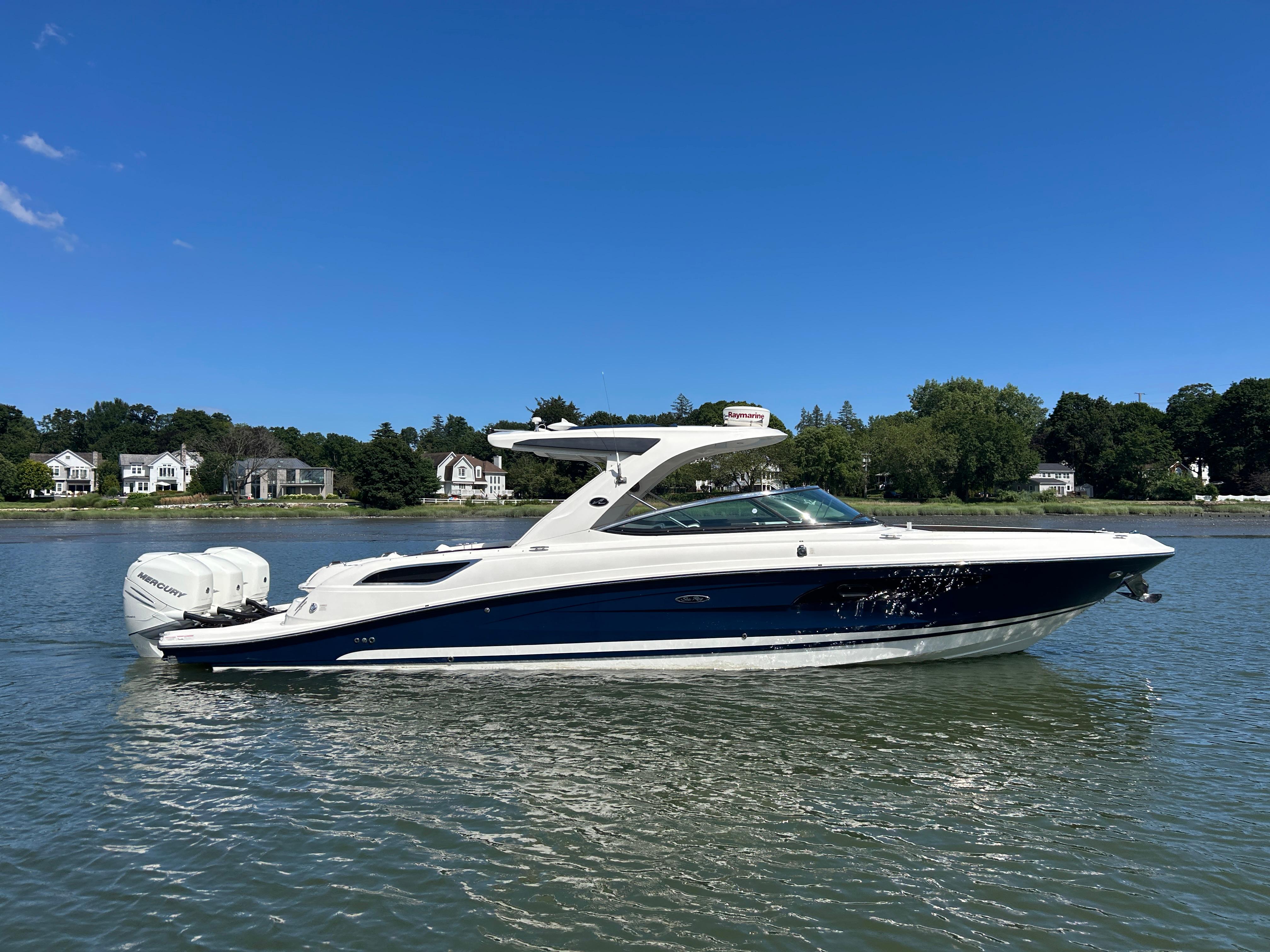 Sea Ray SLX 350 Outboard 2017 Sea Ray SLX 350 Outboard boat on calm water, with scenic shoreline background.