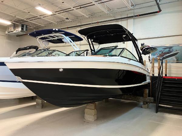 Cobalt R4 Surf 2024 Cobalt R4 Surf boat in showroom, black and white exterior, modern design.