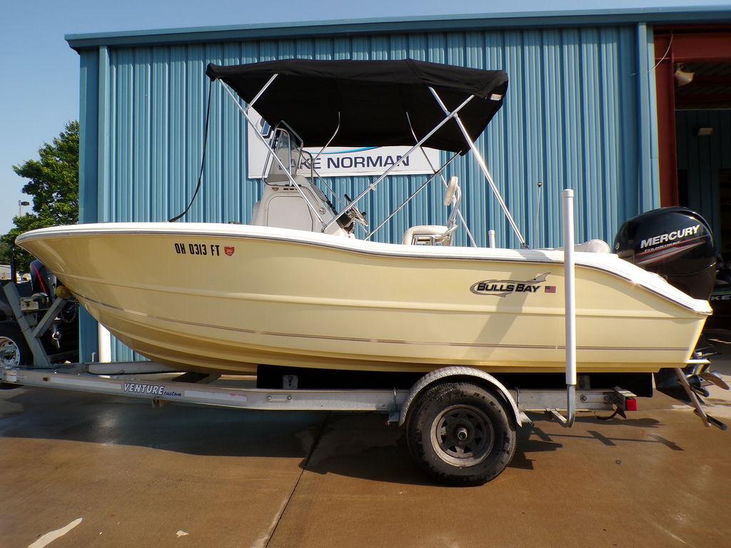 Bulls Bay 200CC 2016 Bulls Bay 200CC boat on trailer, parked outside a blue building.