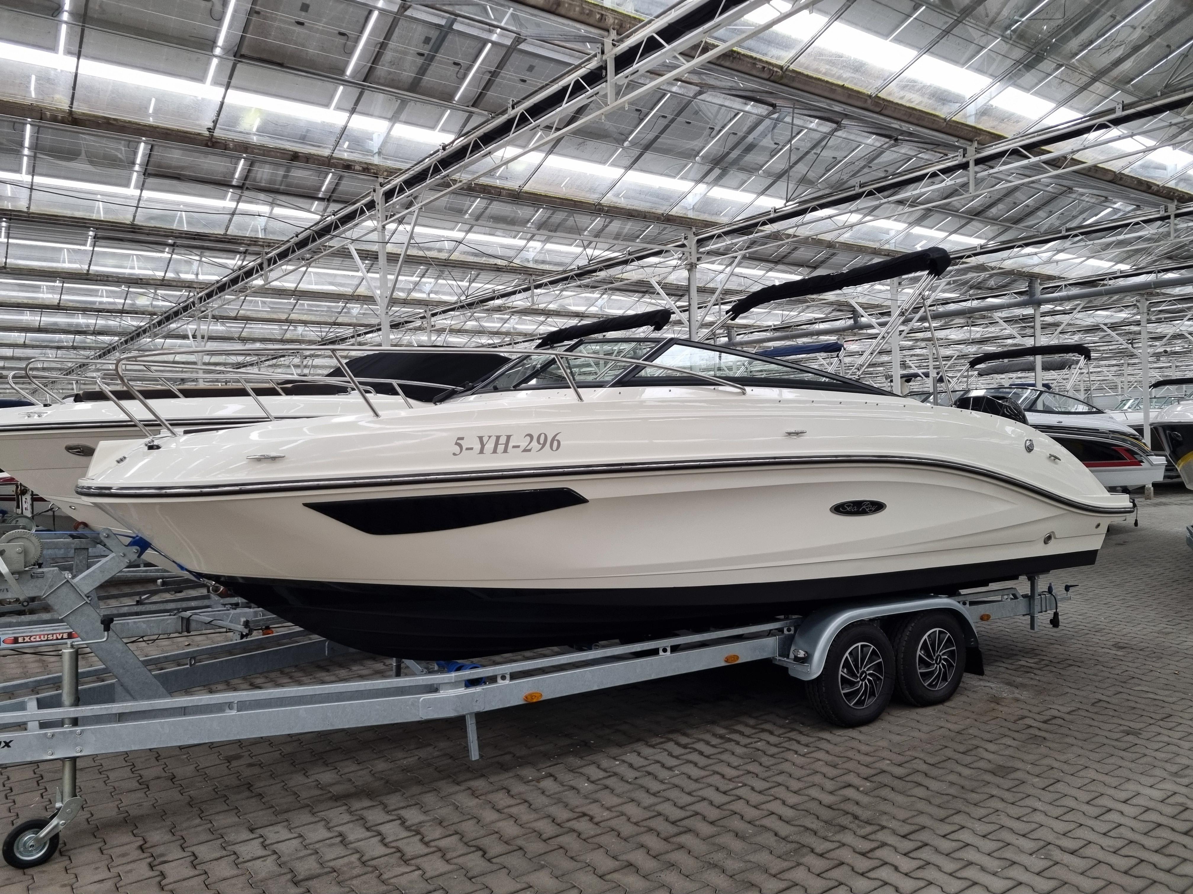 Sea Ray Sun Sport 230 OB 2022 Sea Ray Sun Sport 230 OB boat on trailer in indoor showroom.