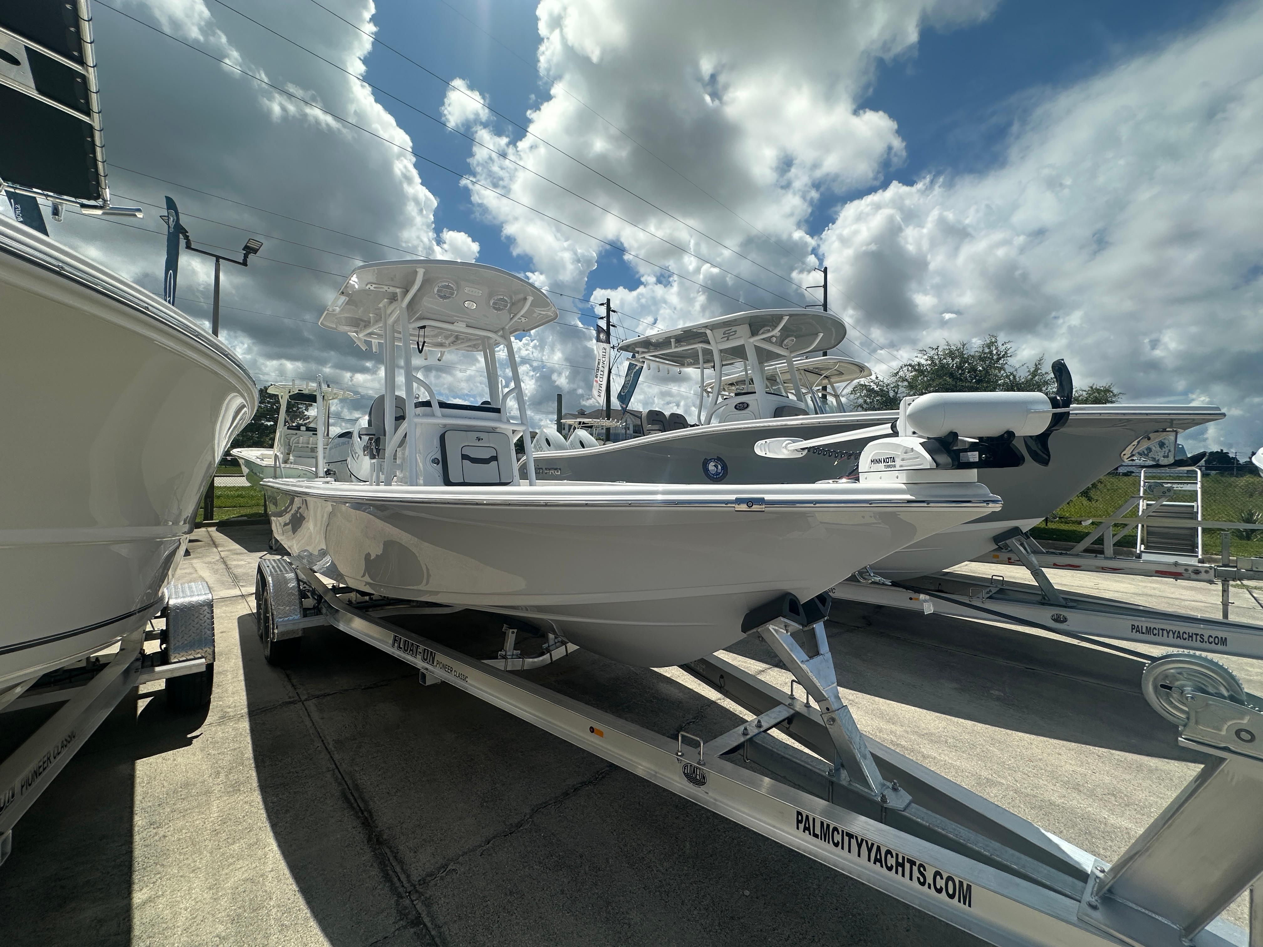 Sea Pro 230 Bay 2025 Sea Pro 230 Bay boat on trailer under cloudy sky at dealership.