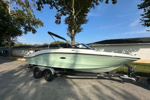 Sea Ray SPX 210 2024 Sea Ray SPX 210 boat on trailer, parked outdoors under trees.