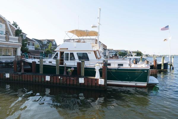 Sabreline 47 Motor Yacht 2000 Sabreline 47 Motor Yacht docked at a marina with waterfront homes.