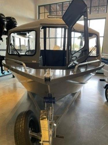 Spartan 200 Astoria 2024 Spartan 200 Astoria boat on display in a showroom.