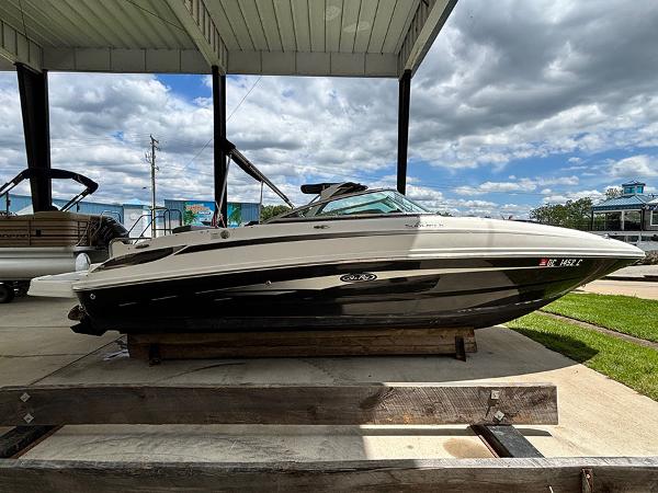 Sea Ray 240 Sundeck 2011 Sea Ray 240 Sundeck boat displayed under a canopy on a sunny day.