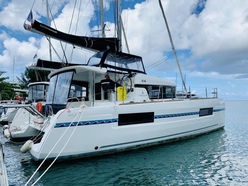 Lagoon 40 2019 Lagoon 40 catamaran docked in a marina under a partly cloudy sky.