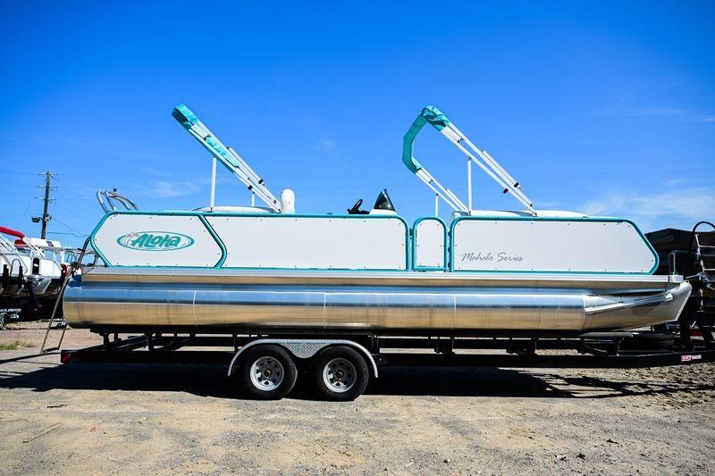 Aloha Mahalo 23 2023 Aloha Pontoon Mahalo 23 on trailer, featuring sleek design and vibrant accents.