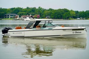 Saxdor 320 GTO 2023 Saxdor 320 GTO boat on calm water, surrounded by lush greenery.
