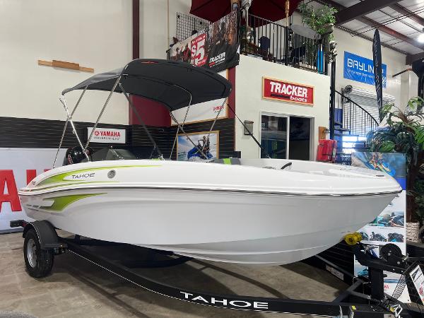 Tahoe T18 2024 Tahoe T18 boat on display in showroom with canopy and trailer.