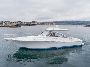 Viking 38 Open Billfish 2022 Viking 38 Open Billfish yacht cruising in a calm harbor setting.