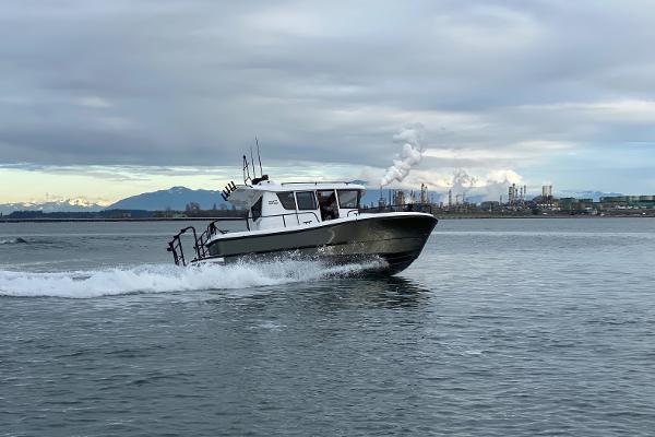 Sargo 25 Sargo 25 boat cruising on water, 2021 model, industrial background.