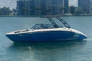 Yamaha Boats AR240 2017 Yamaha Boats AR240 in blue on calm water, with cityscape background.