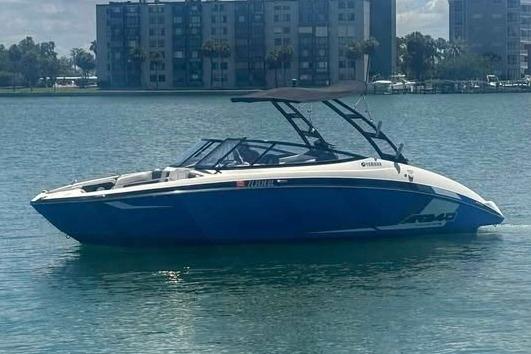 Yamaha Boats AR240 2017 Yamaha Boats AR240 in blue on calm water, with cityscape background.