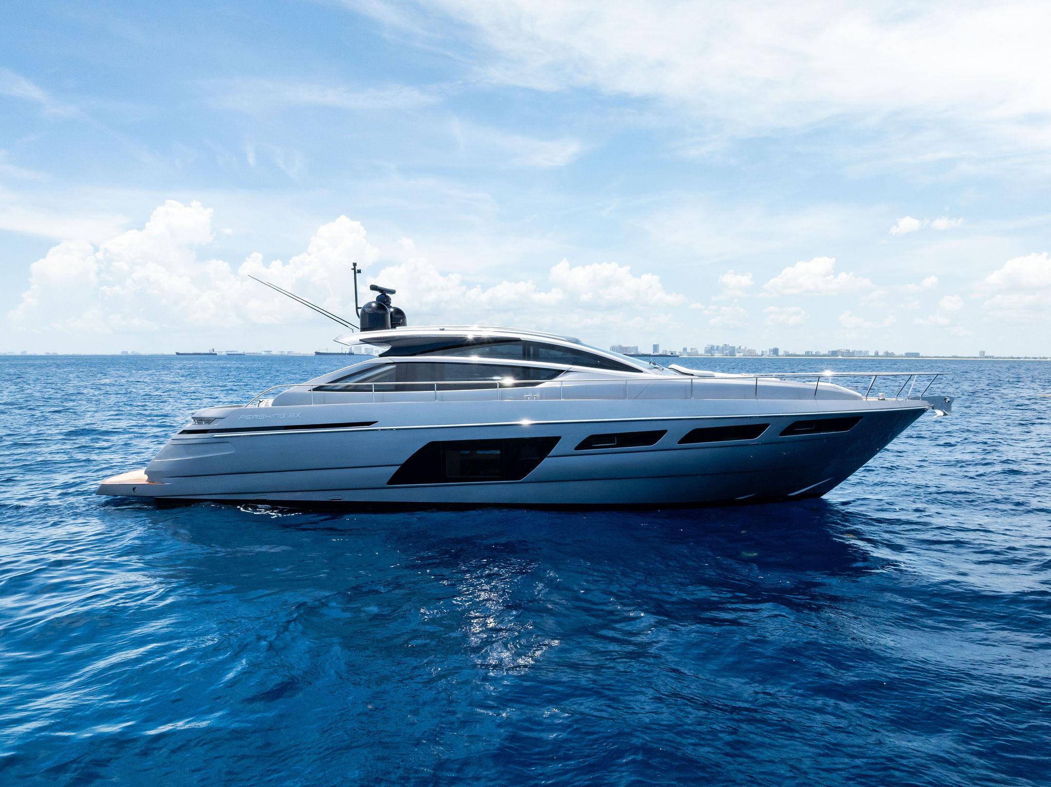 Pershing 6X 2024 Pershing 6X yacht cruising on open blue sea under clear sky.