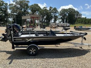 Xpress H18C Crappie 2026 Xpress H18C Crappie boat on trailer, parked outdoors under clear sky.