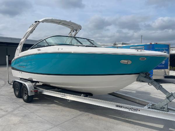 Regal LS4 2024 Regal LS4 boat on trailer, blue and white exterior, docked outdoors.