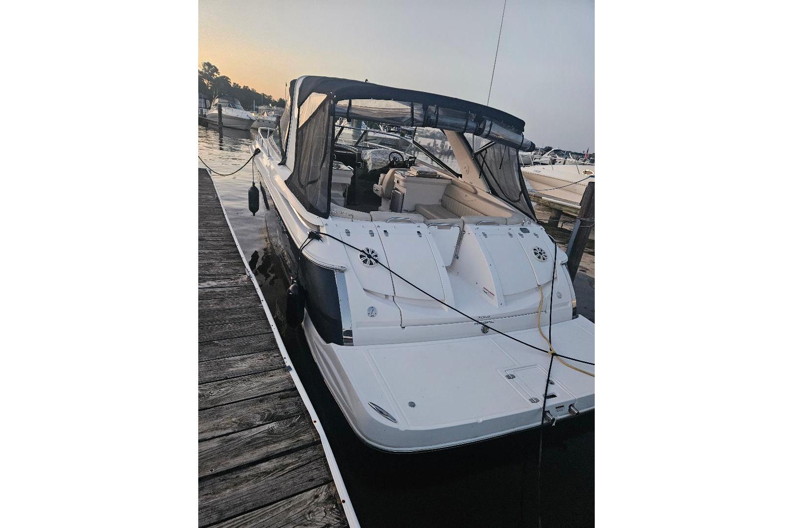 Regal 3350 Cuddy 2010 Regal 3350 Cuddy boat docked at marina during sunset.