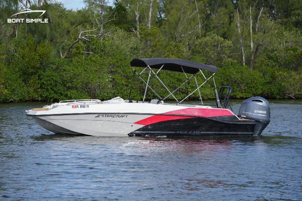 Starcraft SVX 210 2023 Starcraft SVX 210 boat on calm water with lush greenery background.