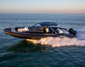Pirelli 50 2025 Pirelli 50 boat cruising on open water at sunset.