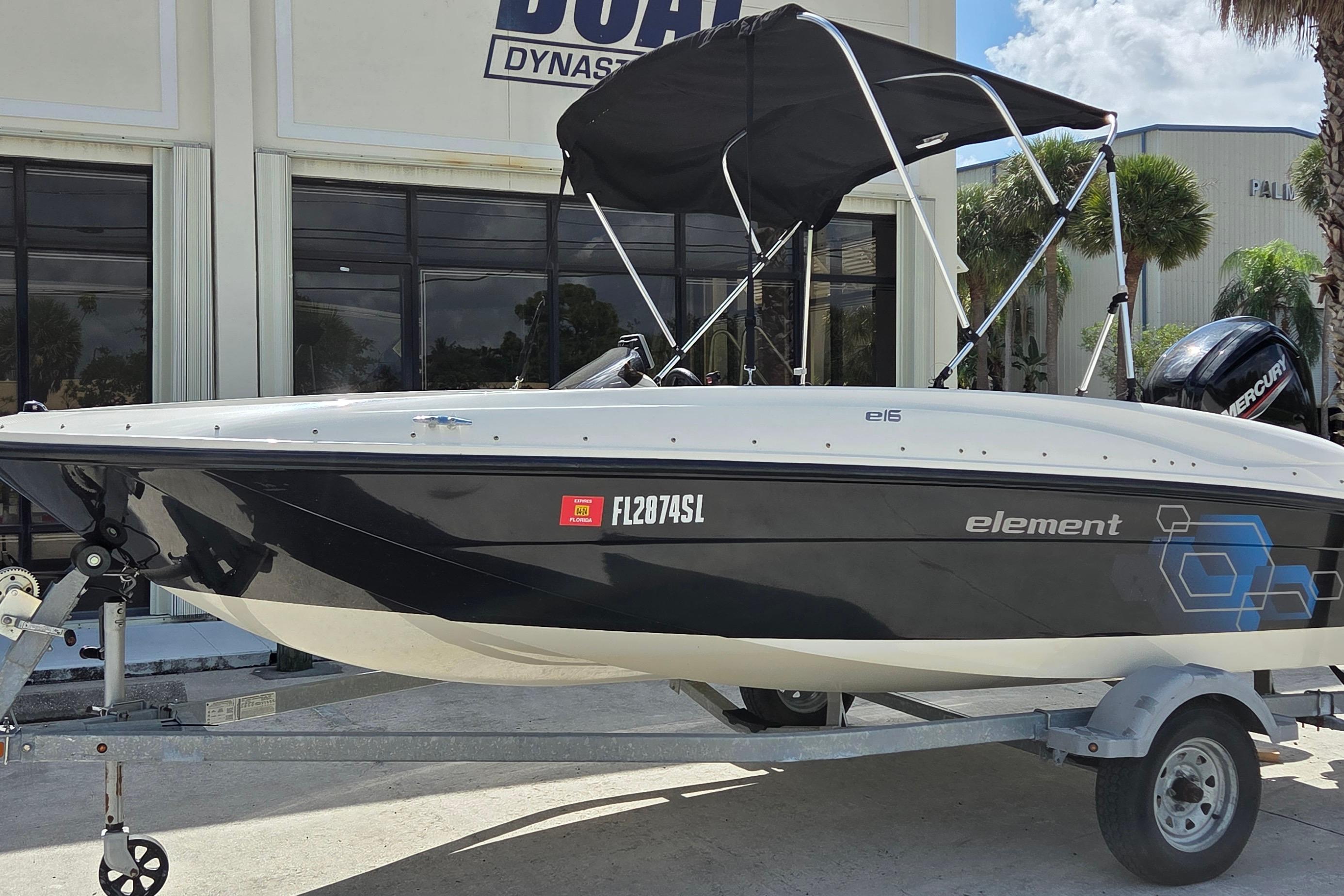 Bayliner Element E16 2020 Bayliner Element E16 boat on trailer, parked outside dealership.