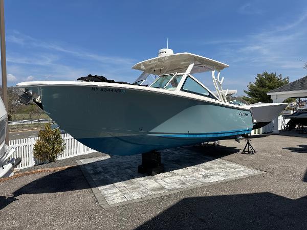 Sailfish 276 DC 2022 Sailfish 276 DC boat displayed outdoors on a sunny day.