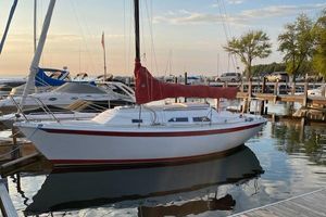 Ericson 25+ 1981 Ericson 25+ sailboat docked at marina during sunset.