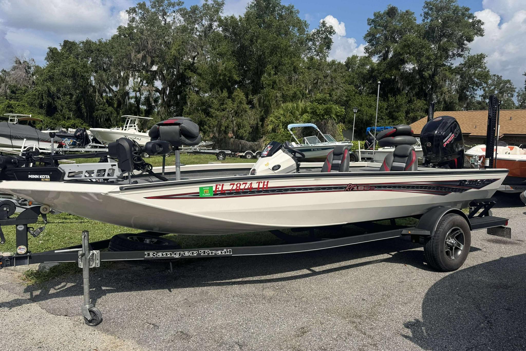 Ranger RT188P 2021 Ranger RT188P boat on trailer, parked outdoors with trees in background.