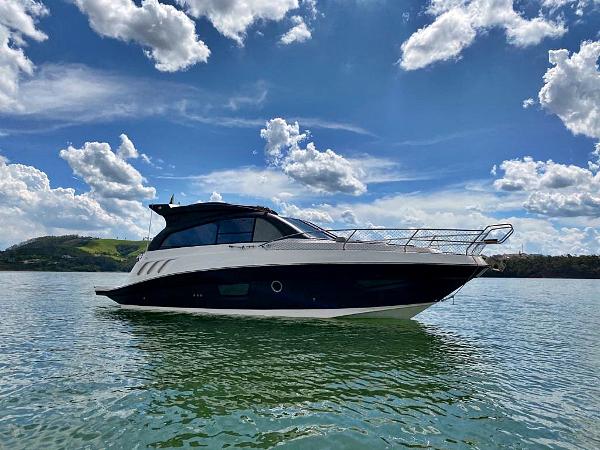 Hanover 355 Outboard 2025 Hanover 355 Outboard boat on a sunny lake with blue skies.