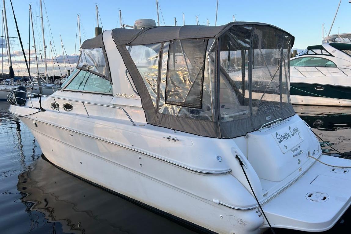 Sea Ray 310 Sundancer 2000 Sea Ray 310 Sundancer boat docked at marina, featuring enclosed cockpit.