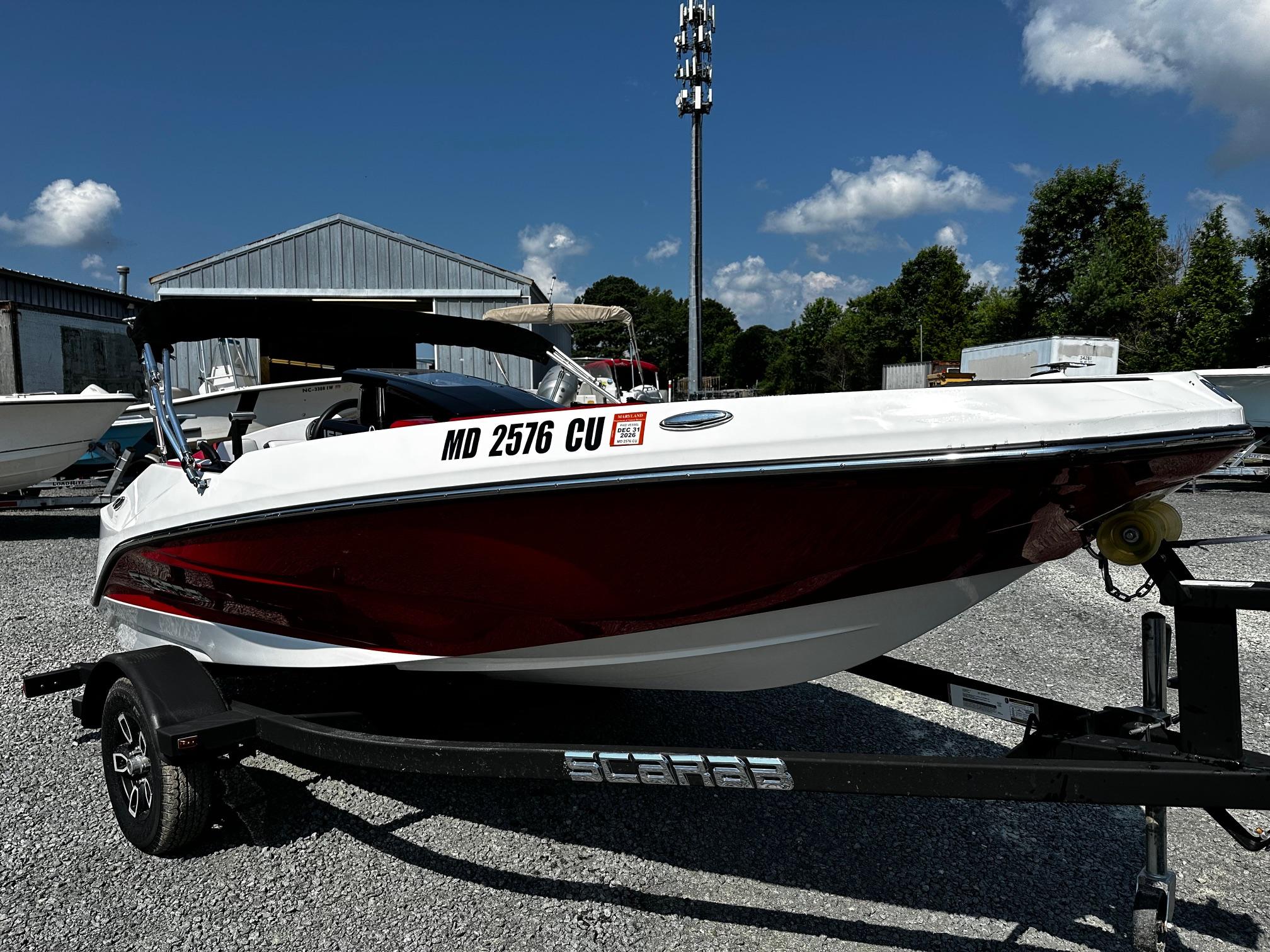 Scarab 165ID Jet Boat 2023 Scarab 165ID Jet Boat on trailer, parked outdoors under blue sky.