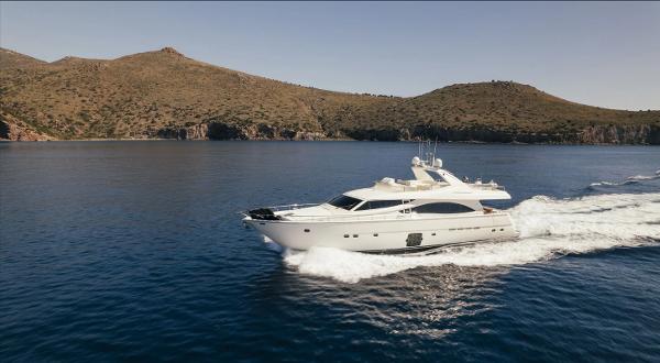 Ferretti Yachts 830 Luxurious 2006 Ferretti Yachts 830 cruising on serene waters with scenic hills in the background.