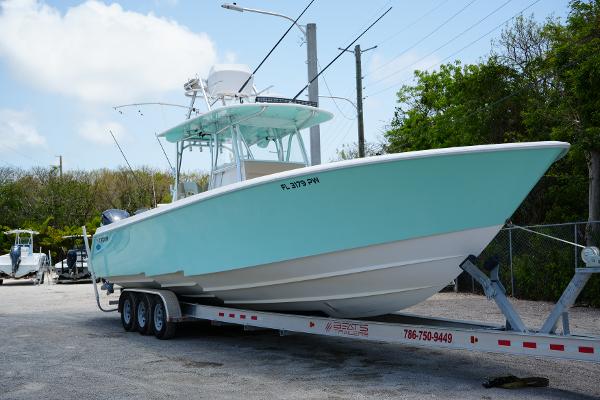 Contender 39ST 39 ST 2015 Contender 39ST boat on trailer, light blue hull, parked outdoors.