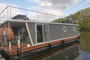 Woma Houseboat Houseboat WOMA D13 Modern 2022 Woma D13 houseboat with rooftop deck on a serene lake.
