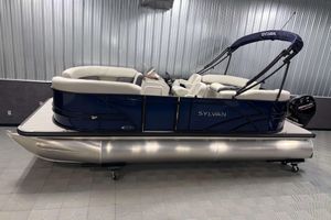 Sylvan Mirage 820 LZ 2026 Sylvan Mirage 820 LZ pontoon boat with blue exterior and white seating in showroom.