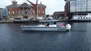 Axopar 28 Cabin BRABUS Trim Aft Cabin 2023 Axopar 28 Cabin BRABUS Trim Aft Cabin cruising in a scenic harbor setting.