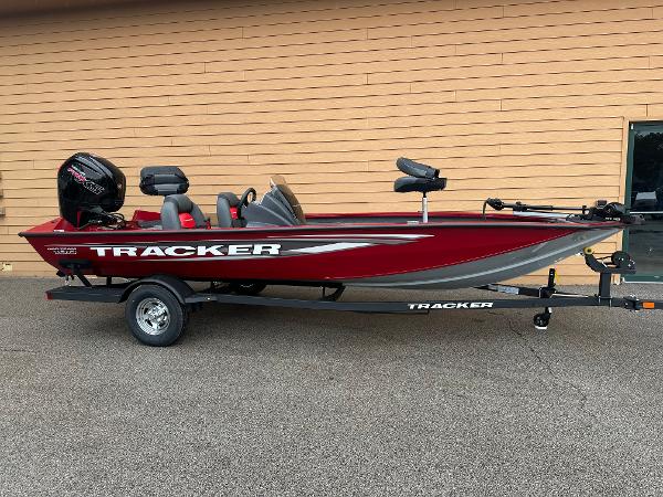 Tracker Pro Team 190 2025 Tracker Pro Team 190 boat, red and gray, on a trailer, parked outdoors.