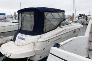 Monterey 250 Cruiser 2005 Monterey 250 Cruiser docked at marina with blue canopy.