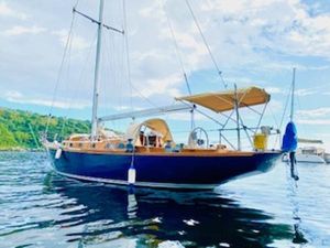 Sparkman & Stephens 47' Classic 1967 Sparkman & Stephens 47' sailboat on tranquil water under a blue sky.