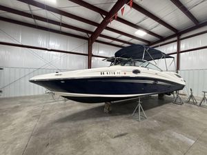 Sea Ray 300 Sundeck 2013 Sea Ray 300 Sundeck boat in storage, blue and white exterior, indoor facility.