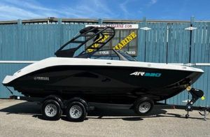 Yamaha Boats AR220 2025 Yamaha Boats AR220 on trailer, black and white design, parked outdoors.
