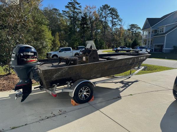 G3 Gator Tough 18 CC Camo 2023 G3 Gator Tough 18 CC Camo boat on trailer, parked in driveway.