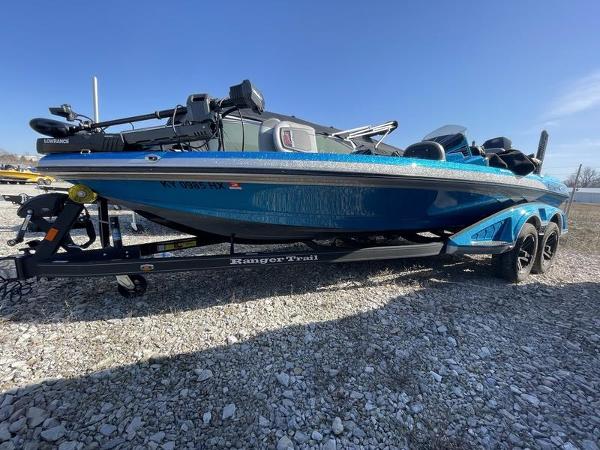 Ranger Z520R 2023 Ranger Z520R bass boat on trailer, blue exterior, parked on gravel.