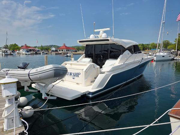 Tiara Yachts C44 Coupe 2016 Tiara Yachts C44 Coupe docked at a marina with a small dinghy attached.