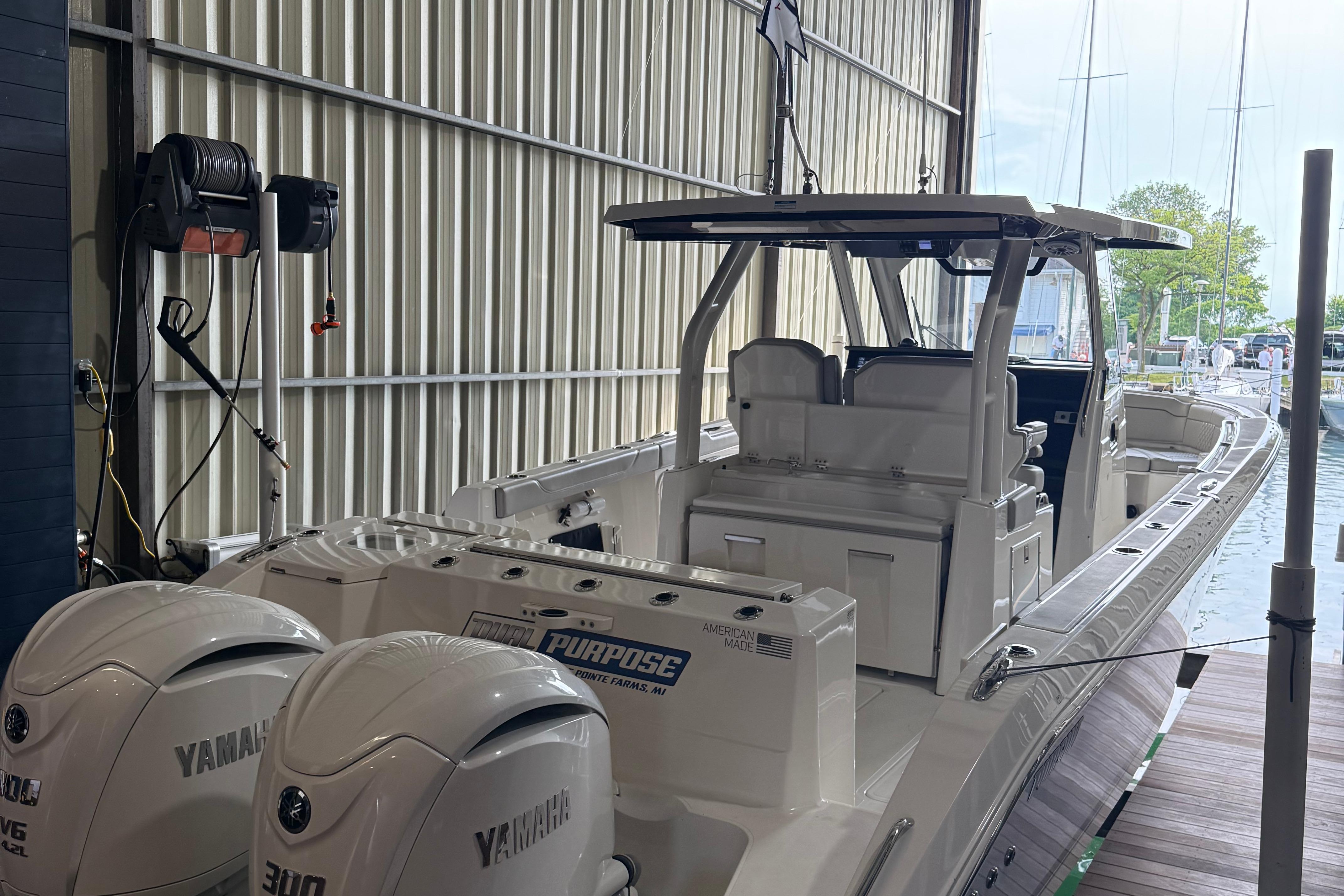 Pursuit S 328 Sport 2022 Pursuit S 328 Sport boat with Yamaha engines docked indoors.