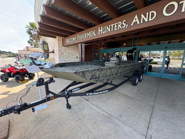 Tracker Grizzly 2072 CC 2025 Tracker Grizzly 2072 CC boat displayed outside a store entrance.