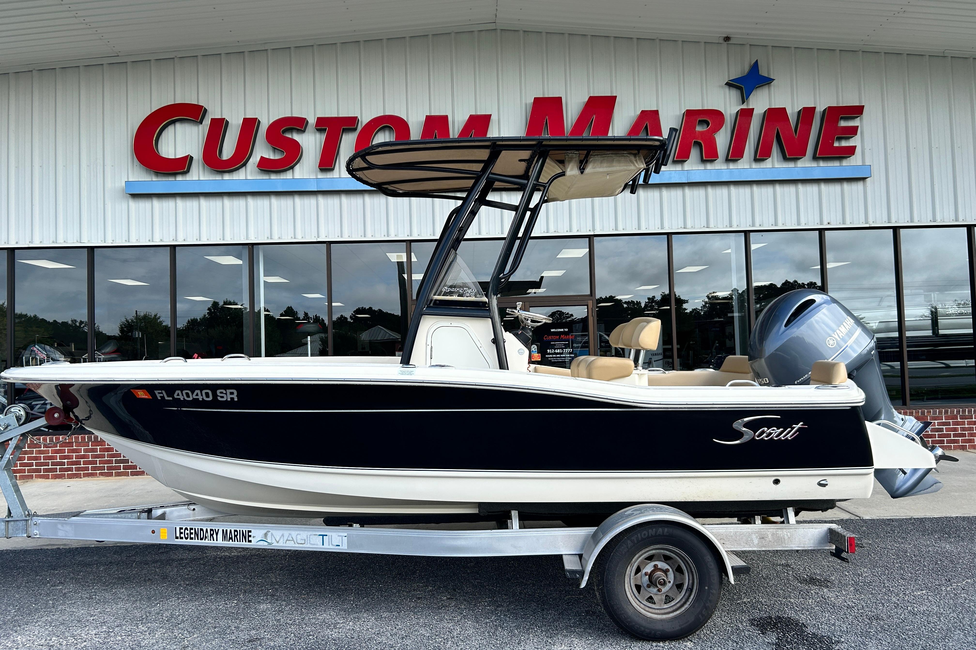 Scout 195 Sportfish 2020 Scout 195 Sportfish boat on trailer outside Custom Marine dealership.