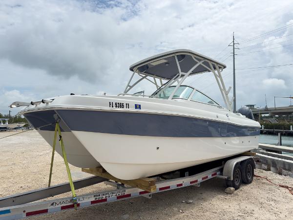 World Cat 230 SD 2022 World Cat 230 SD boat on trailer, parked outdoors under cloudy sky.